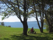 Visitors relaxing on the grounds of Fort Anne looking out over the Annapolis Basin.