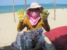 Viet Nam lady dressed for the sun at the beach!