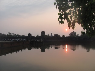 Beautiful sunrise reflected on the lake in front of the temple at Ankor