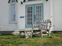 Driftwood chairs in front of the church